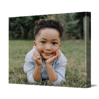 Canvas prints: A landscape canvas print with a full-bleed photo of a boy lying in the grass.