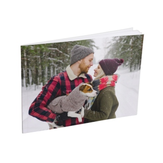 5x7 Softcover Photo Book: A small softcover photo book with a full-photo cover of a couple with their dog in the snow.