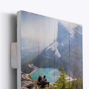 Rustic Wood Prints: A side view of a photo printed on rustic vertical wood planks, showing a couple looking at a mountain lake.