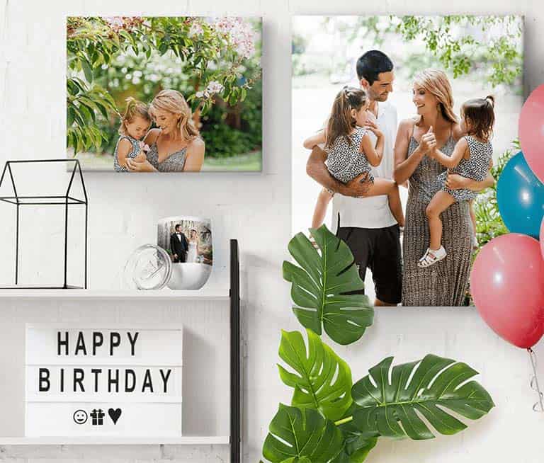 Grownup Gifts: A display of personalized birthday gifts including two photo canvas prints and a travel mug.