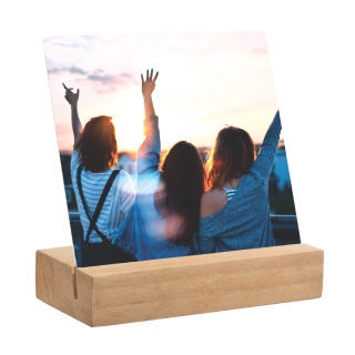 Metal Desk Art: A square metal photo print of three friends at sunset, displayed in a wooden block stand.