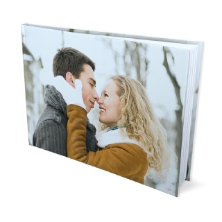 8x11 Hardcover Photo Book: A landscape hardcover photo book with a full-photo cover of a couple in winter.