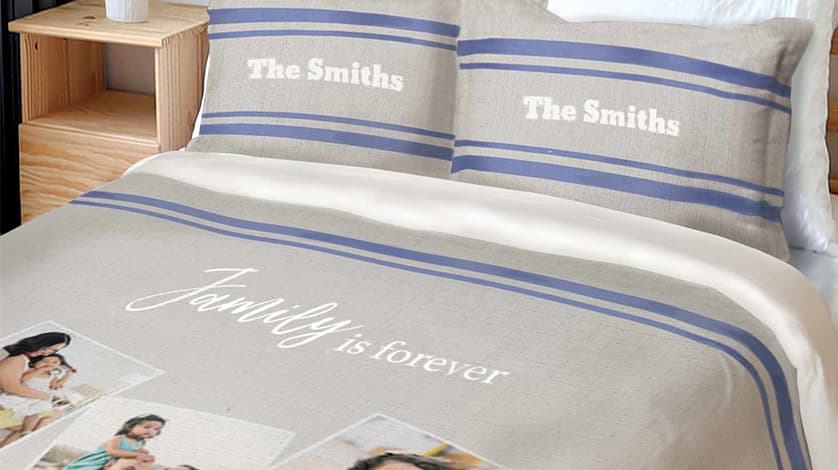 Shop Personalized Pillowcases: A bed with a personalized duvet cover and matching pillowcases featuring a family name and photo collage.